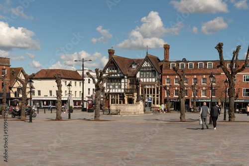 Salisbury, Wiltshire, England, UK. 2023. People walk on Market Place in the city centre surrounded with historic buildings, shops and offices.