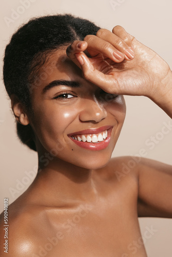 Canvas Print Beautiful black african model with flawless skin smooth complexion applying mois