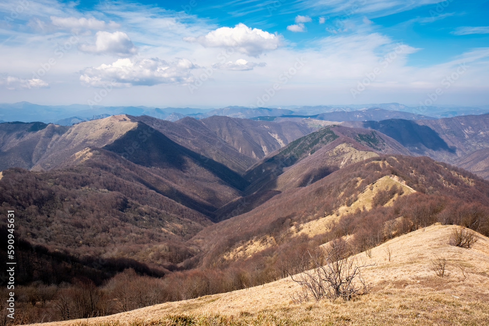 Springtime panorama of the Ligurian Apennines, towards the Piedmont side, seen from the top of Antola mountain; is a small peak on the borders between Piedmont and Liguria (Northern Italy).