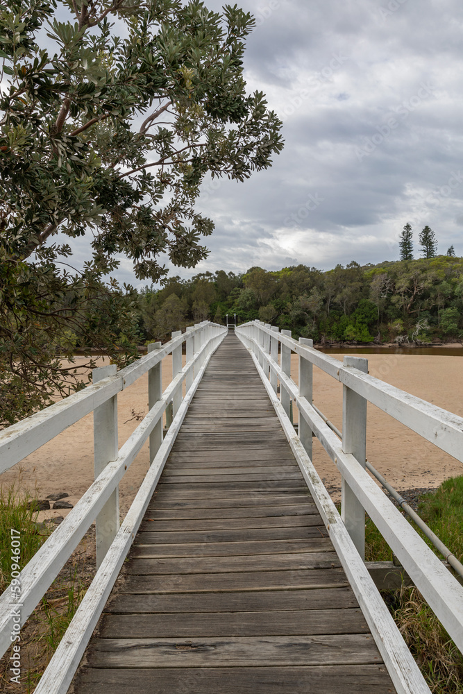 Wooden bridge over the river - foot bridge from Hat Head, across Korogoro Creek, to Hat Head National Park, NSW, Australia