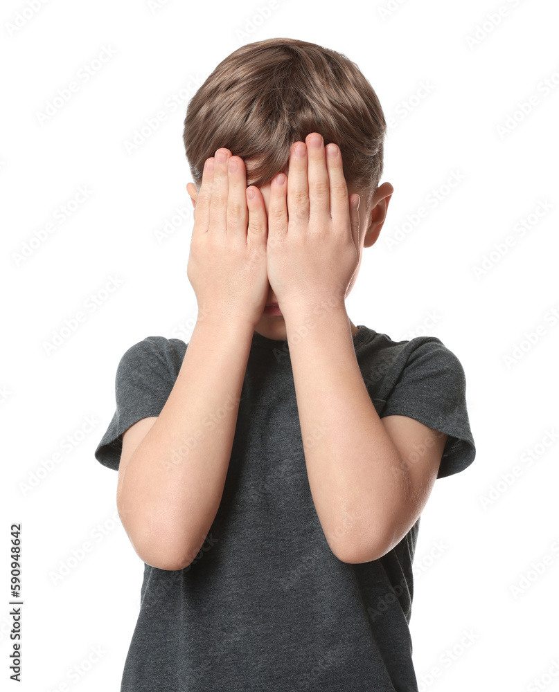 Boy covering face with hands on white background. Children's bullying Boy covering face with hands on white background. Children's bullying