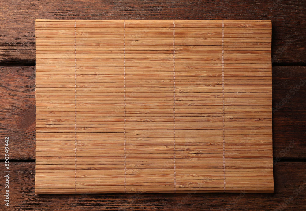 Bamboo mat on wooden table, top view. Space for text