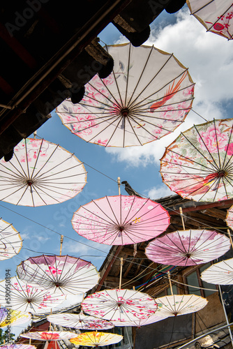 Close up on the paper umbrellas as a roof against the sun and the blue sky behind it  Lijiang Old Town