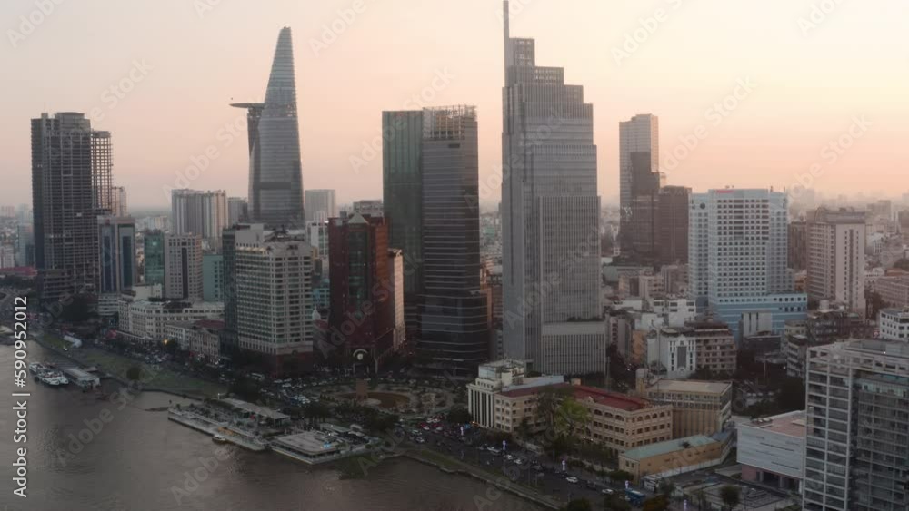 Aerial view of cityscape with modern skyscrapers in downtown on the riverbank during sunrise, drone shot Aerial view of cityscape with modern skyscrapers in downtown on the riverbank during sunrise, drone shot