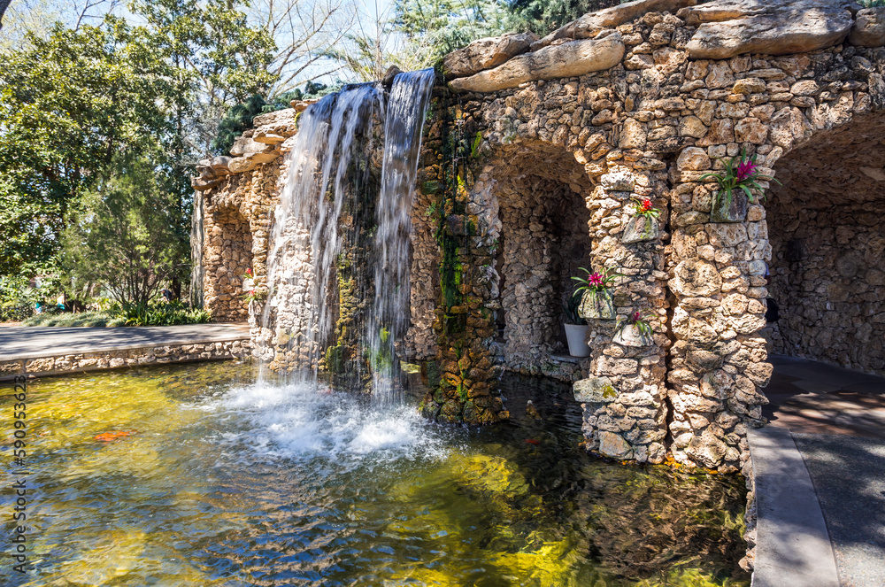 Beautiful manmade waterfalls and brick wall in the public park in Dallas, Texas