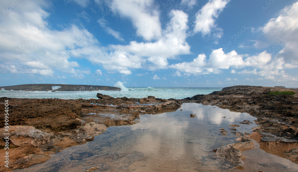 Obraz premium Sky reflections and storm waves crashing into Laie Point coastline at Kaawa on the North Shore of Oahu Hawaii United States