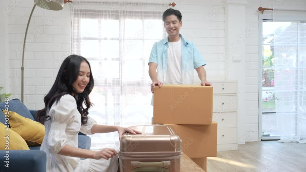 Asian couple carry a large cardboard box into the new home. Asian couple carry a large cardboard box into the new home.