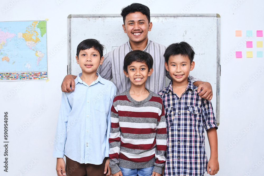 Potrait of teacher and diverse schoolboy smiling and look at the camera at the classroom. Potrait of teacher and diverse schoolboy smiling and look at the camera at the classroom.