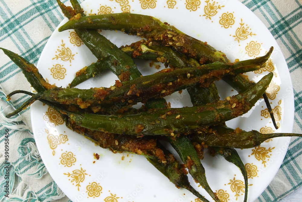 indian gujarati style chili or chilli pepper marinated and stir fry