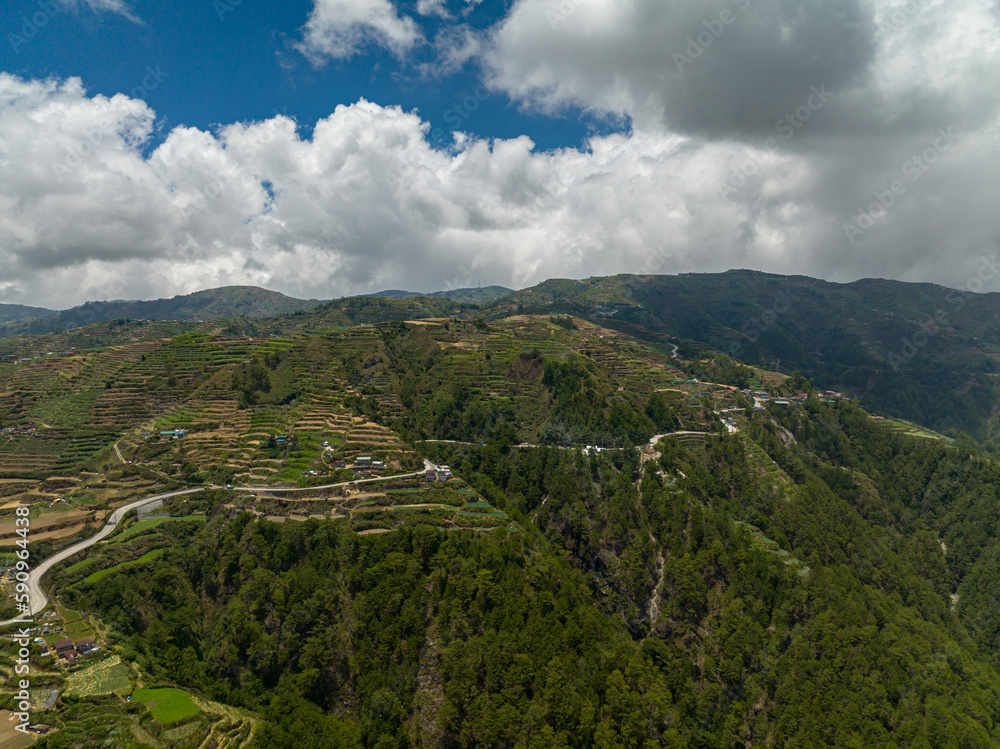 Aerial drone of rice terraces and agricultural land on hillsides in a mountainous province. Philippines, Luzon.