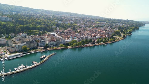 Stunning aerial drone shots of the french lake side town of Evian Les Bains. Situated on the clear blue waters of Lake Geneva on the Swiss, French Border and surrounded by high alpine peaks. photo