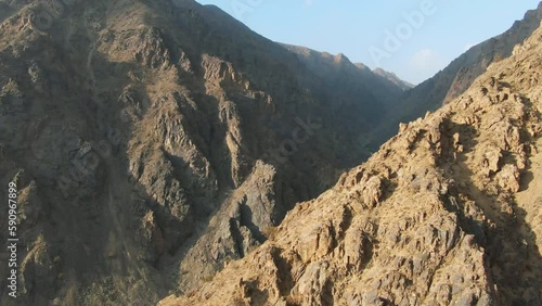 Forward aerial of stony mountains at golden hour in rural Afghanistan photo