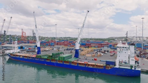 Big cargo ship being unloaded at Haina Port with port cranes, Dominican Republic photo