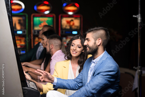 Young Group Playing Automat Machine in a Casino