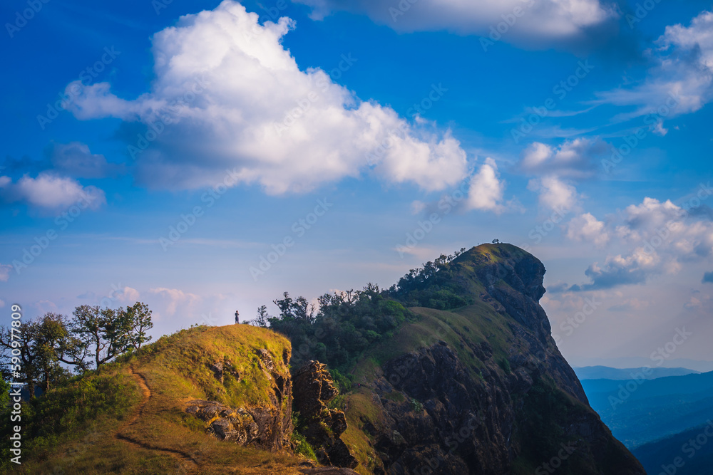 A man standing on the back of lion mountain in the northern of Thailand (Mon Chong Mt. Chiang Mai province)