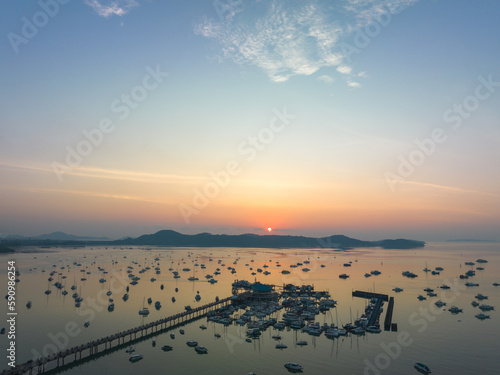 aerial view beautiful sunrise cloud above Chalong pier..Sunrise with sweet yellow color light rays and other atmospheric effects..colorful reflection of sunrise in the sea background.