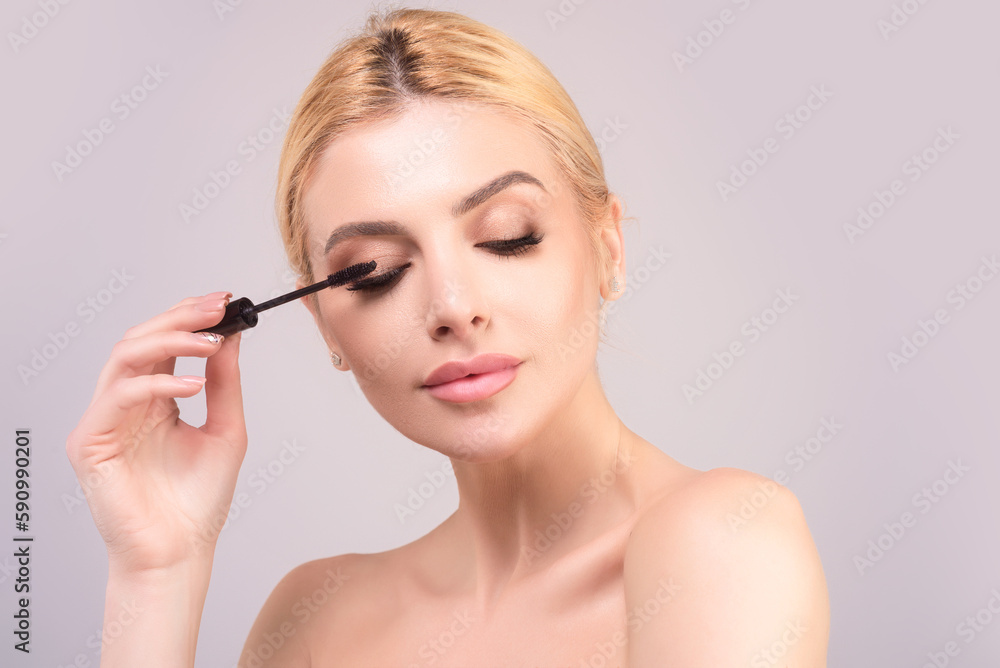Woman comb eyelashes with eyelashes brush. Care for lashes, eyebrows lamination. Eyelashes beauty procedures. Beautiful woman with long eyelashes.