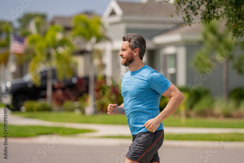 Middle aged millennial hispanic man 40s jogging outside in morning, senior sportsman enjoying active healthy lifestyle. Male athlete sports model fit and healthy life.