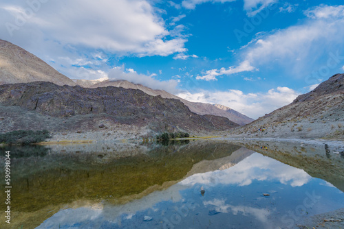 mountains  clouds and sky are reflected on the lake. Beautiful scenery at Yarab Tso valley - Leh Ladakh - India