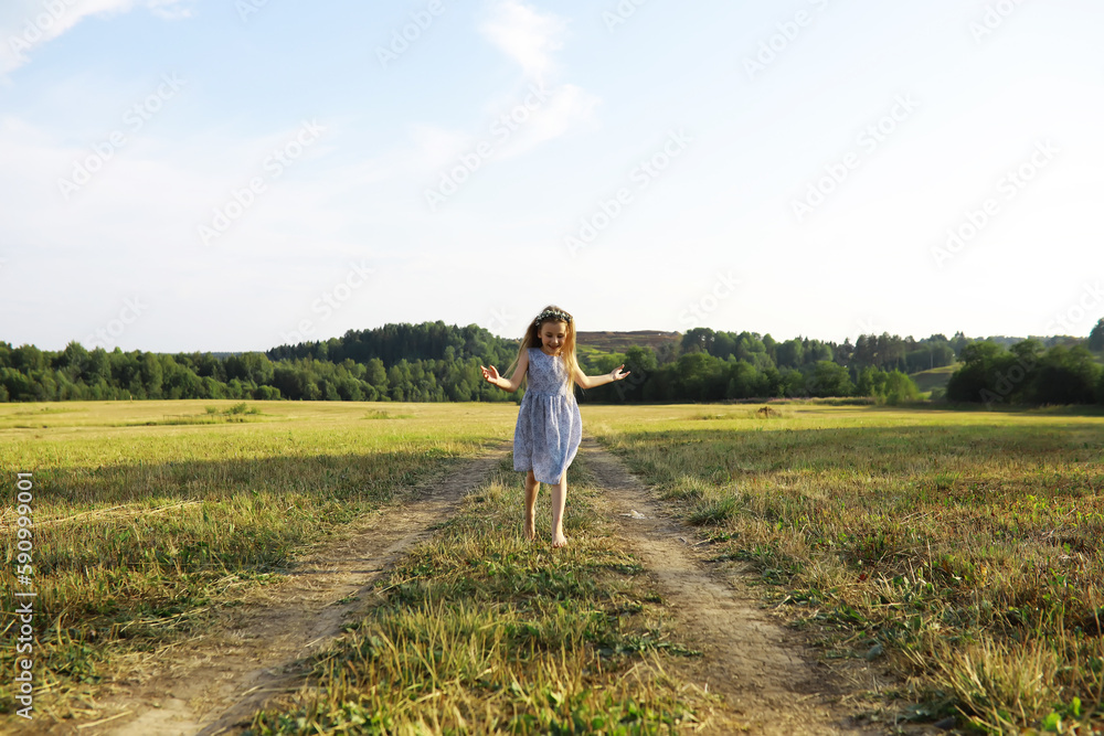 Children walk in the summer in nature. Child on a sunny spring morning in the park. Traveling with children.