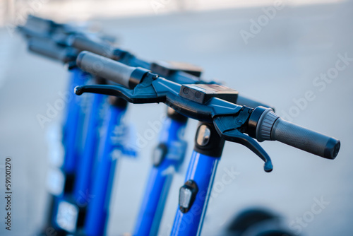 Electric scooters are parked in the city center. Modern public mobile transport