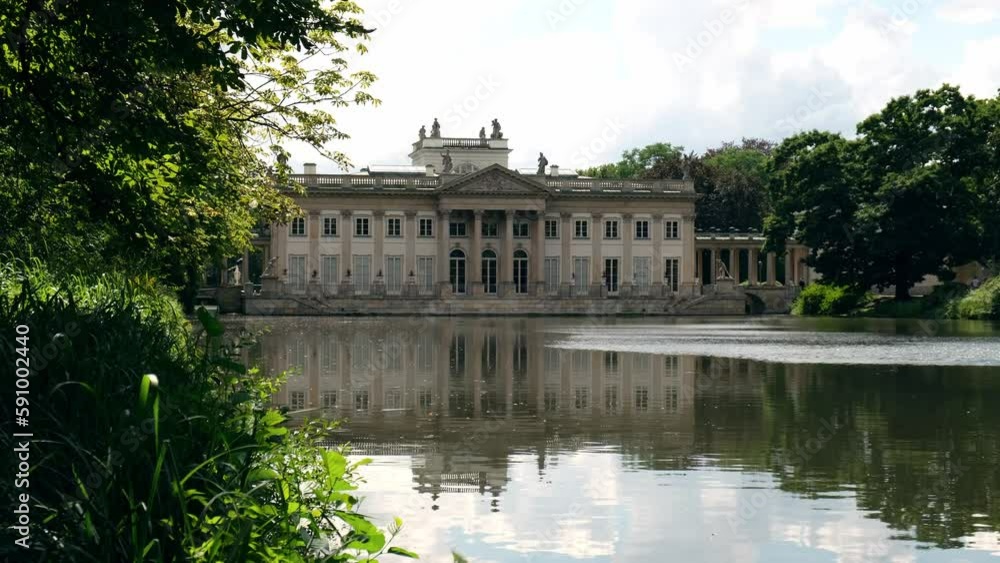 Baths classicist Palace on the Isle in Lazienki Park touristic place in Warsaw. Lazienki Royal Baths Park, Warsaw Poland. Mirror Reflection on the Lake. Nature in summer Baroque columns Baths classicist Palace on the Isle in Lazienki Park touristic place in Warsaw. Lazienki Royal Baths Park, Warsaw Poland. Mirror Reflection on the Lake. Nature in summer Baroque columns