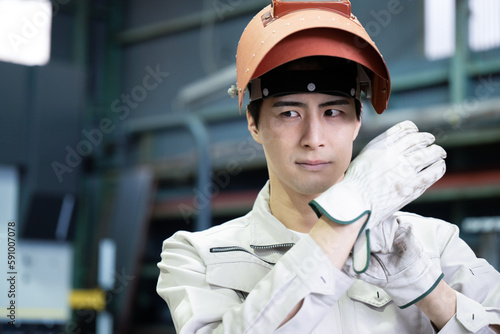 The Image of Manufacturing Recruitment Smiling man in work clothes with mask used for arc welding, etc. © kapinon