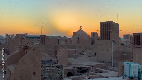 Baadgir wind catcher brick mosque dome mud clay house and ruins of old city of Yazd Ardakan in the sunrise early morning sun shadow time
clear clean blue sky palm date tree and local people living photo