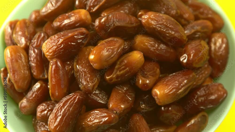 Dates. Dried date palm fruits. Healthy sweet snack food bowl. Pile of tasty dry dattes in plate. Date harvest symbolizing Ramadan. Dates. Dried date palm fruits. Healthy sweet snack food bowl. Pile of tasty dry dattes in plate. Date harvest symbolizing Ramadan.