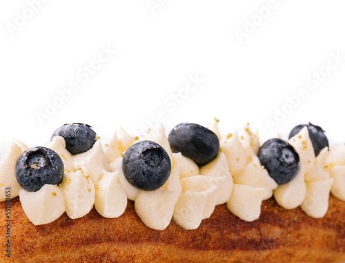 Eclair with buttercream and blueberries close up