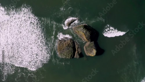 Top View Of Ocean Waves Approaching And Splashing The Rocks At Copalis Beach In Washington, United States. aerial photo