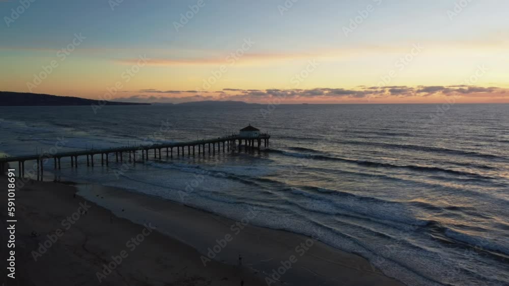 Sea Waves Crawling Onto Shoreline In Manhattan Beach Pier During Sunset In California, United States. Aerial Wide Shot