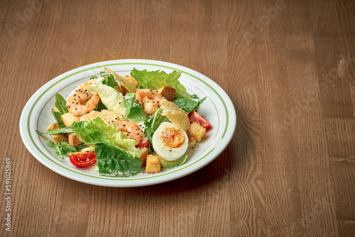 Salad with vegetables, tuna and boiled egg. Nicoise salad. Wooden background