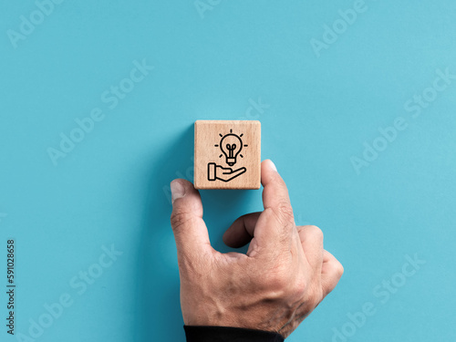New idea or solution suggestion concept. Creative strategy suggestion for business success and growth. Hand places the wooden cube with new idea suggestion symbol. photo