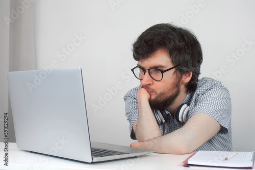 Wallpaper Mural Disabled man in glasses with amputated two stump hands studying on laptop at home, distance education. Problem of adaptation to life people with disabilities. Independent Invalid person. Torontodigital.ca