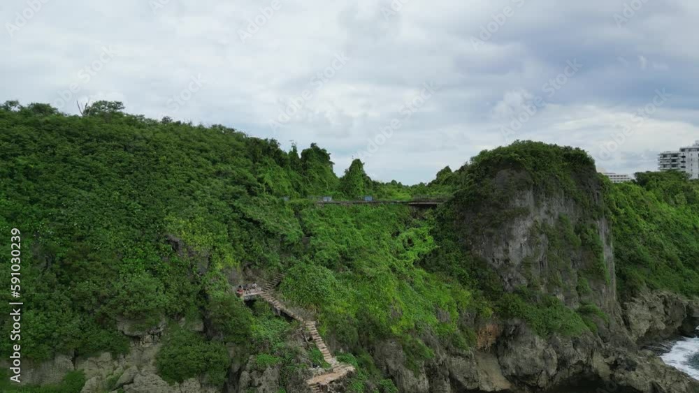 Stunning Nature View Of Cliff Side And Buildings At Oka Point Island In Guam, United States. Pull back aerial Stunning Nature View Of Cliff Side And Buildings At Oka Point Island In Guam, United States. Pull back aerial