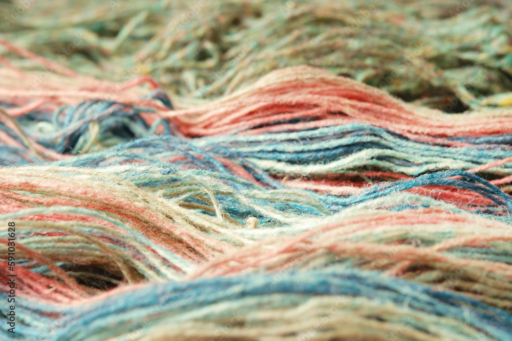 Threads from natural organic sheep wool. Close-up, macro. Two unwound skeins of green and rainbow knitting yarn. Threads from natural organic sheep wool. Close-up, macro. Two unwound skeins of green and rainbow knitting yarn.