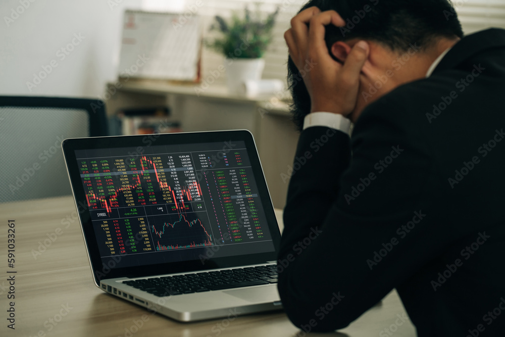 businessman holding his forehead while having headache analyzing stock exchange market crypto trading decreasing chart data fall down loss, desperate about losing money of crisis, recession, inflation businessman holding his forehead while having headache analyzing stock exchange market crypto trading decreasing chart data fall down loss, desperate about losing money of crisis, recession, inflation