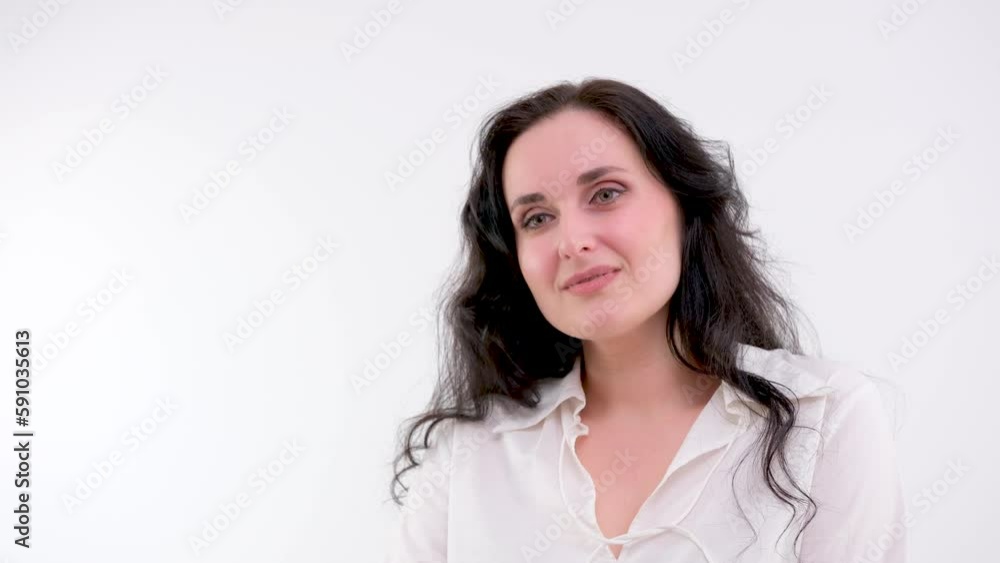 Girl shows different happy emotions of face on a white background, looks into the camera and laughs Girl shows different happy emotions of face on a white background, looks into the camera and laughs