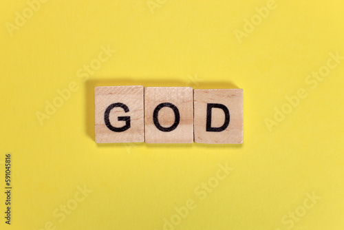 God word from wooden letters on yellow background