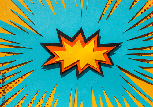Handmade colorful paper cutting speech bubble for your text. Pop art and comic style. Yellow and blue background. 