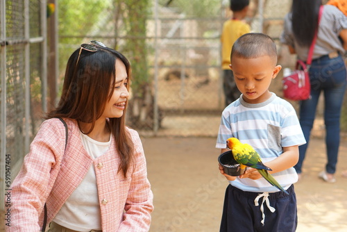 mother and son feeding birds on holiday photo