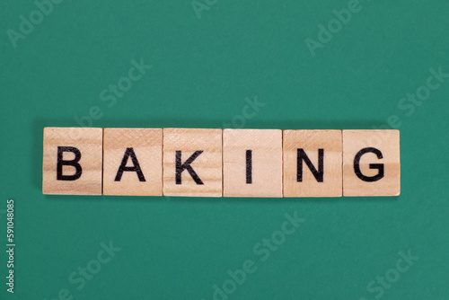 Baking word from wooden letters on green background photo