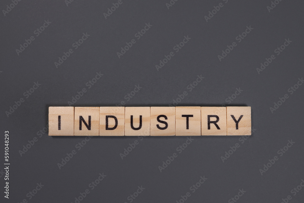 industry word from wooden blocks on gray background industry word from wooden blocks on gray background
