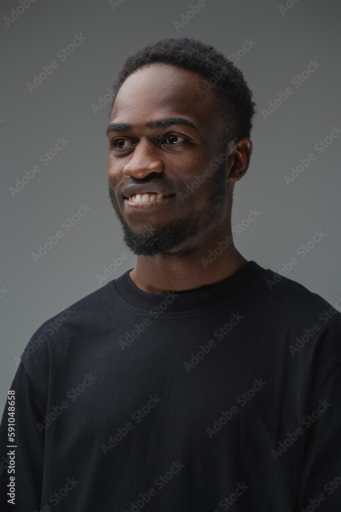 Studio shot of smiling black man with stylish hairstyle dressed in t shirt. Studio shot of smiling black man with stylish hairstyle dressed in t shirt.