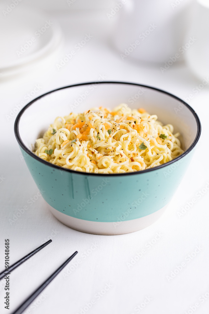 A Turquoise Bowl Filled with Instant Noodles on White and Bright Background A Turquoise Bowl Filled with Instant Noodles on White and Bright Background