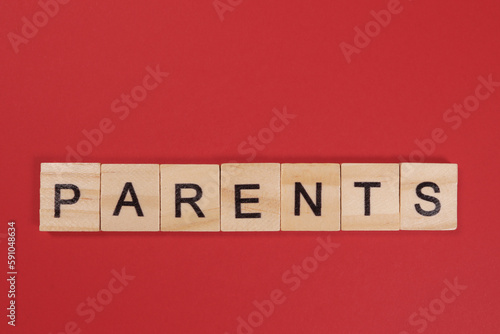 Word Parents from wooden letters on red background