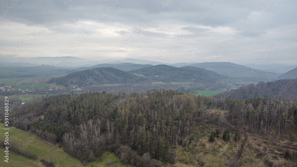 aerial shot of scenic wild nature. Forests, fields, meadows. mountains in the distance in a haze. 