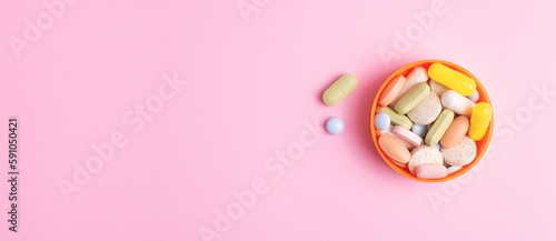 Pharmaceutical web banner with pills and dietary supplements on pink background.