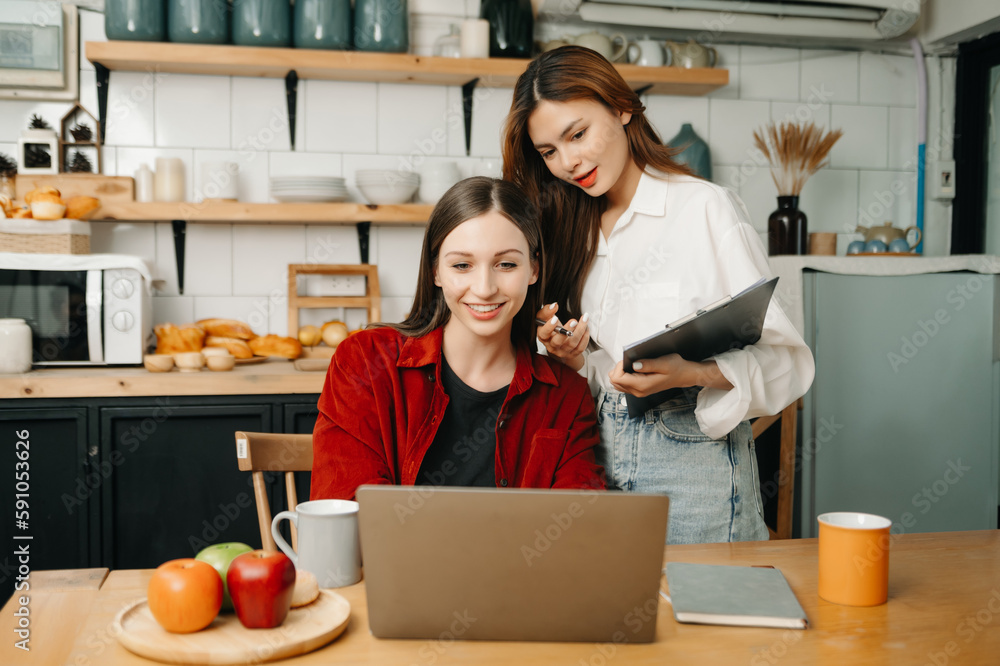 Two business workers talking on the smartphone and using laptop at the office. Two business workers talking on the smartphone and using laptop at the office.